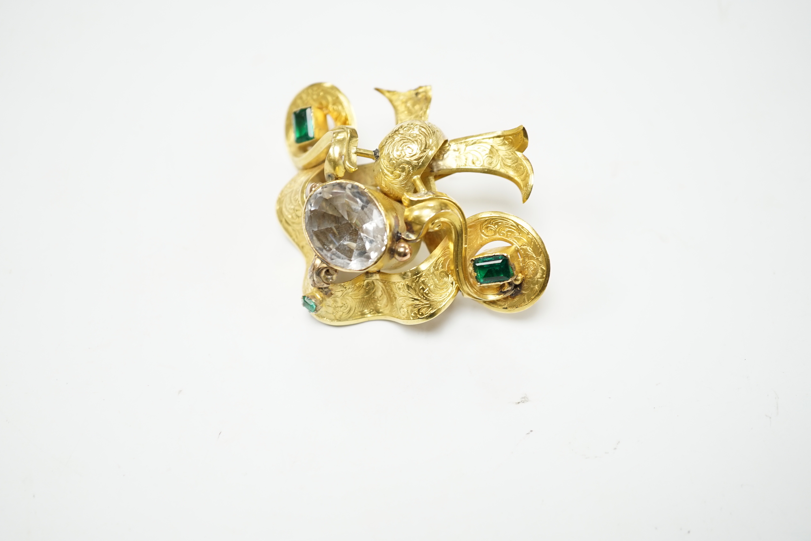 A Victorian engraved yellow metal and foil backed rock crystal and green stone set brooch, width 67mm, gross weight 16.8 grams (a.f.)